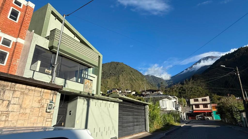 a house on a street with a view of a mountain at Volcán Suits in Baños