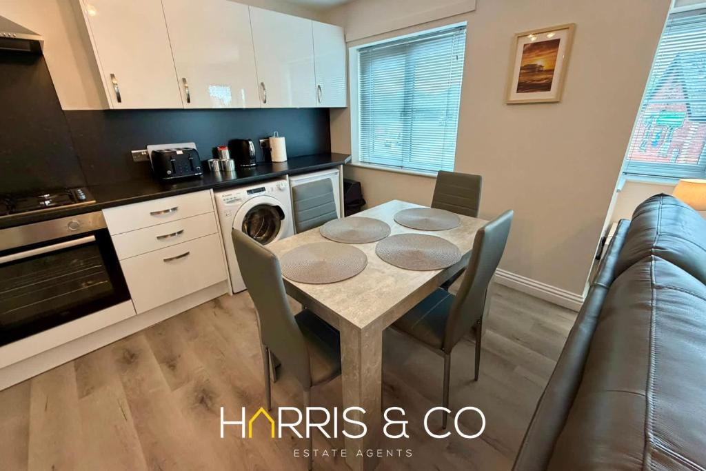 a kitchen with a table and chairs in a room at Upper Marsh Apartment in Thornton