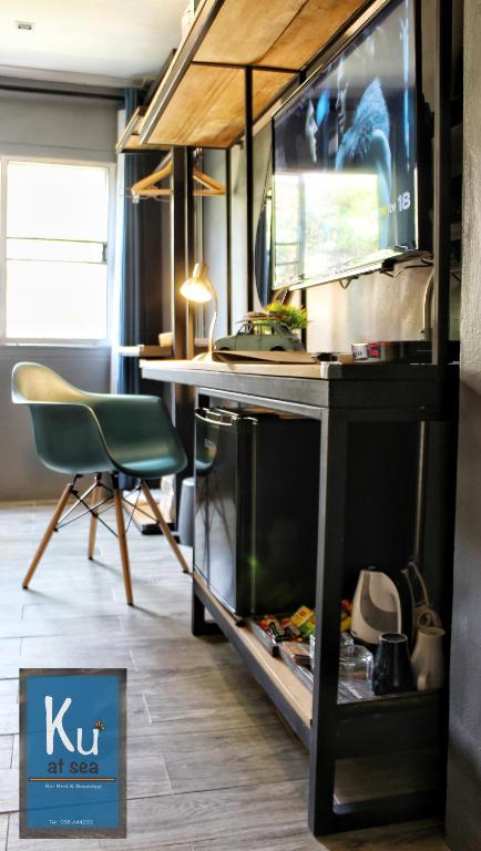 a kitchen with a desk and a chair in a room at Ku at sea in Ko Samed