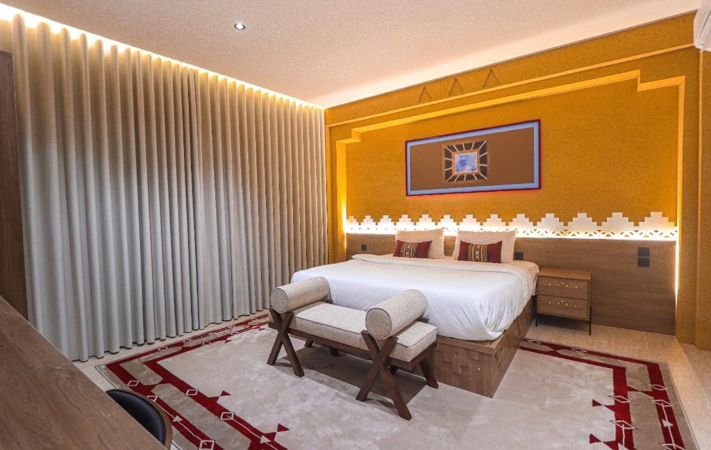 a bedroom with a king sized bed and a chair at نخله للوحدات السكنية 2 in Medina