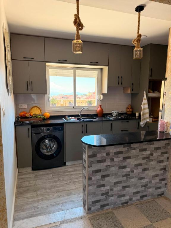 a kitchen with a sink and a dishwasher at Pas de nom in Bouzareah