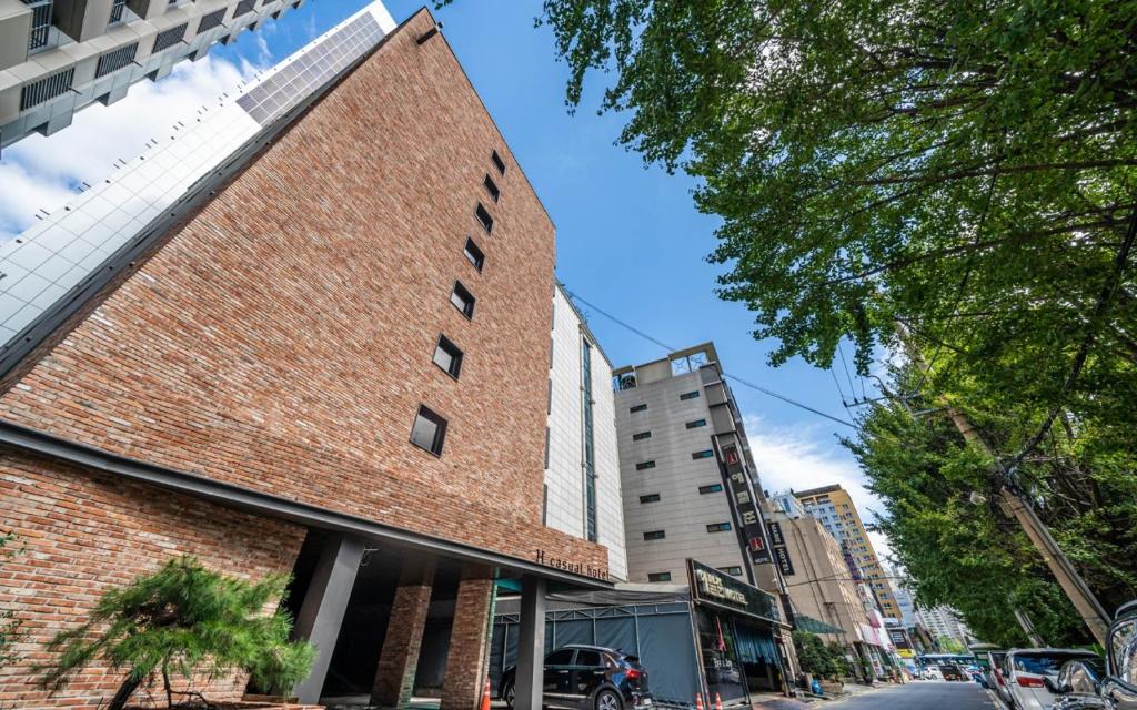 a brick building on a street in a city at H hotel Gasan in Seoul