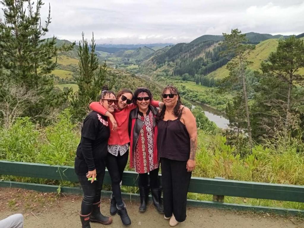 a group of women posing for a picture in the mountains at Parikino School 