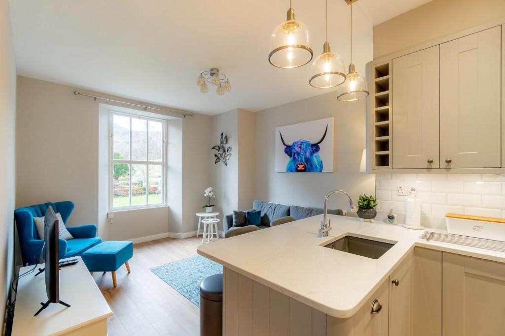 a kitchen with a sink and a living room at 1 Bed in Grasmere oc-lr068 in Grasmere