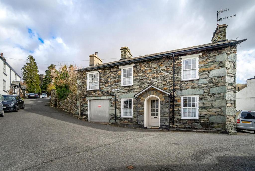an old stone house on the side of a street at 4 Bed in Ambleside oc-lr082 in Ambleside