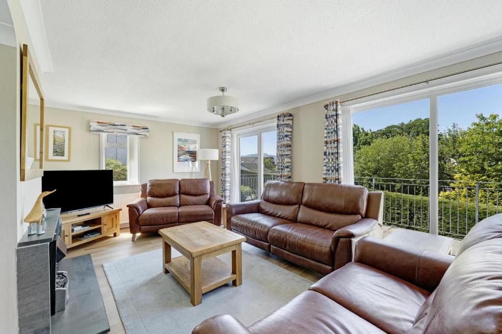 a living room with a couch and chairs and a tv at 4 Bed in Ambleside oc-lr120 in Ambleside
