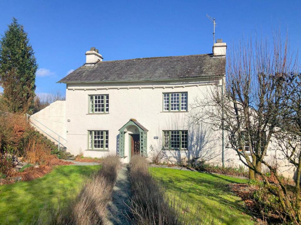 a large white house with a grass yard at 5 Bed in Hawkshead oc-lr134 in Hawkshead
