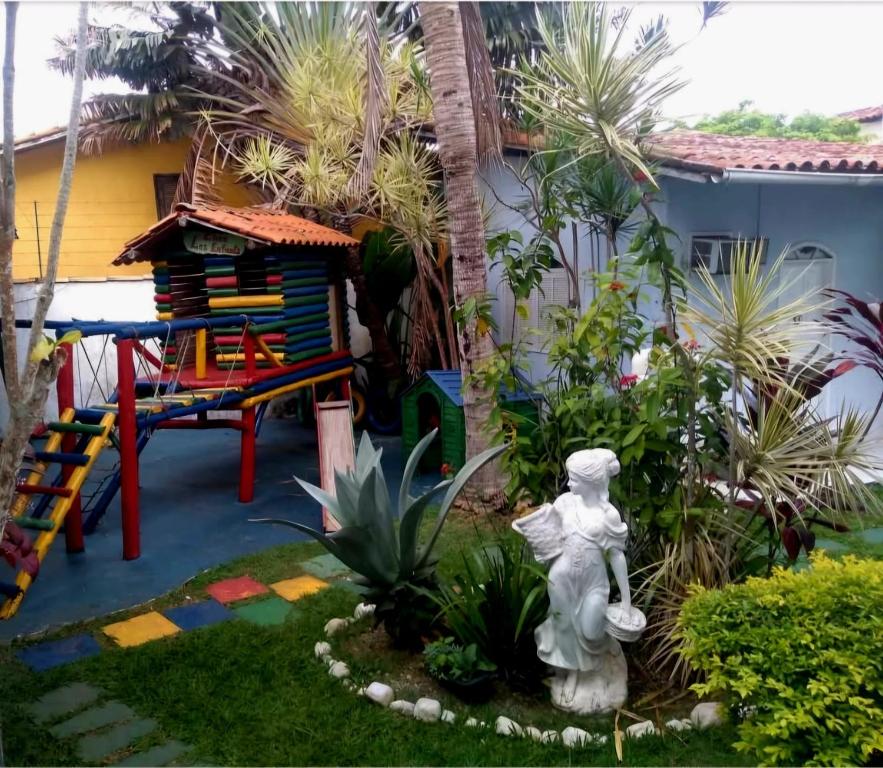a small backyard with a playground and a play area at LM Suítes in Búzios