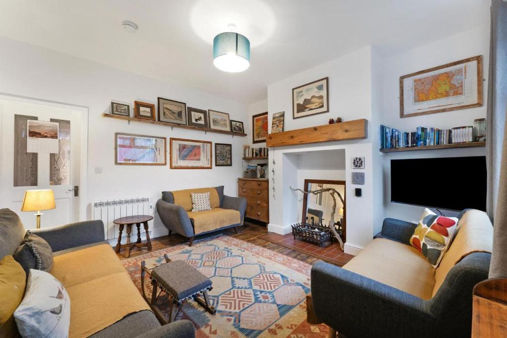 a living room with two couches and a tv at 3 Bed in Coniston oc-lr198 in Coniston