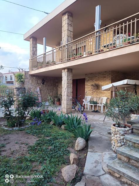 a large house with a balcony and a patio at Cal Bonet in Cerviá