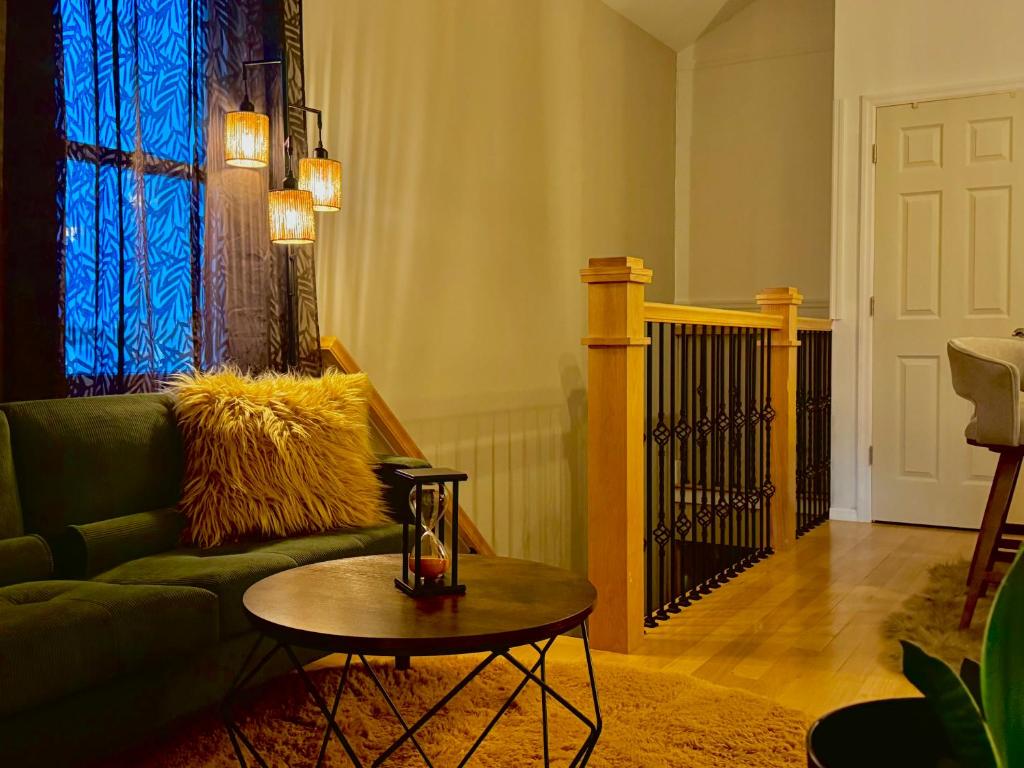 a living room with a green couch and a table at La Suite de Antonio Shared Property PRIVATE stay NYC 18mins in North Bergen