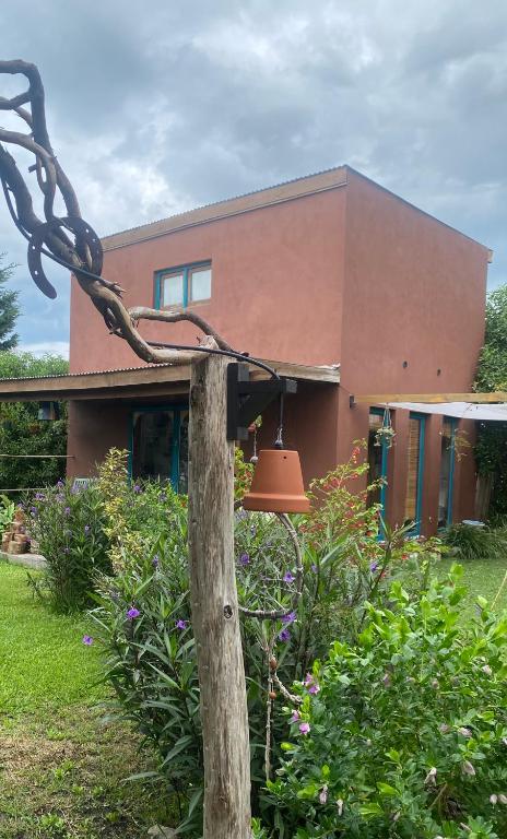 a house with a bell in front of it at Tiny House Marencalma in Santa Clara del Mar