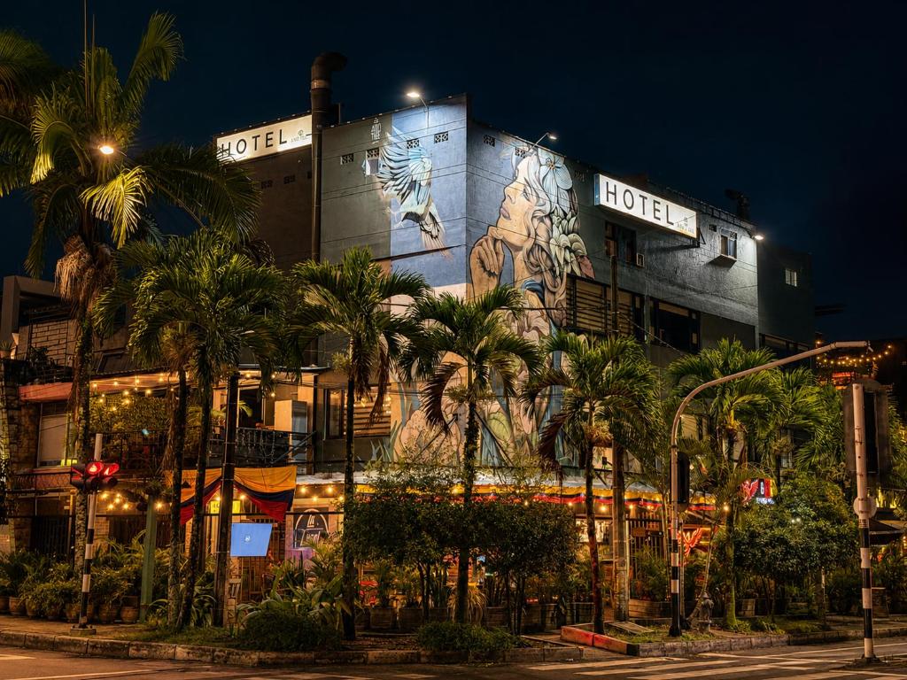 a building with a mural on the side of it at Hotel Laureles Palo Alto in Medellín
