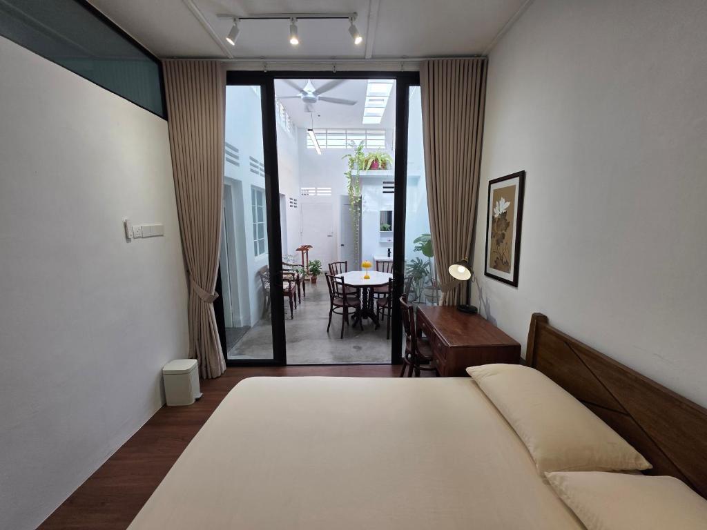 a bedroom with a bed and a dining room with a table at Zen Retreat KL in Kuala Lumpur