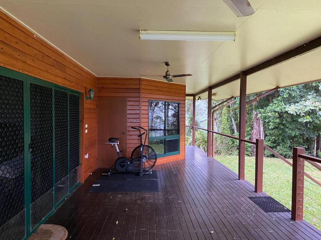 a room with a bike on a wooden deck at Daintree Private Escape in Cow Bay