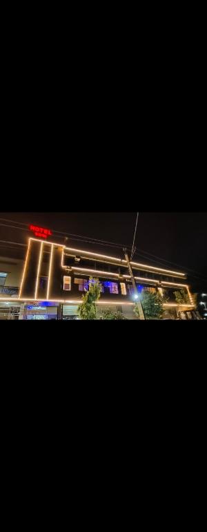 a view of a street at night with lights at Hotel soni plaza in Jhālrapātan