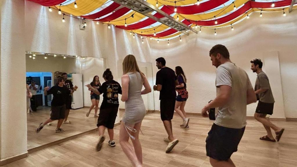a group of people dancing in a dance hall at Til Sunrise in Cali