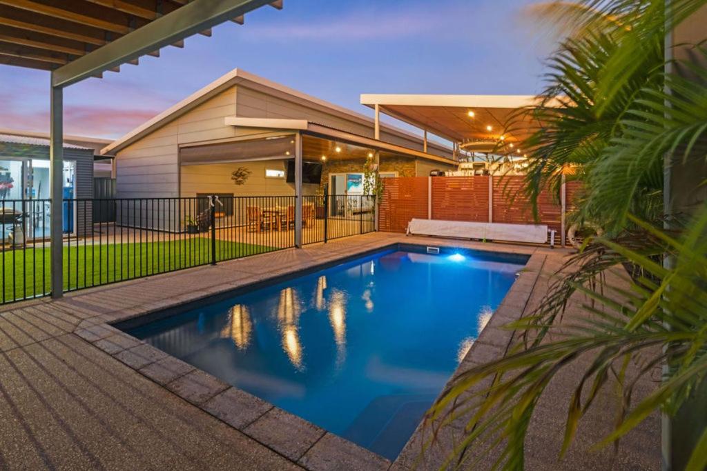 a swimming pool in the backyard of a house at Kingfisher in Exmouth