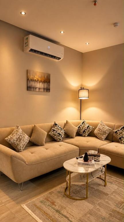 a living room with a couch and a table at Advantage Residence in Medina