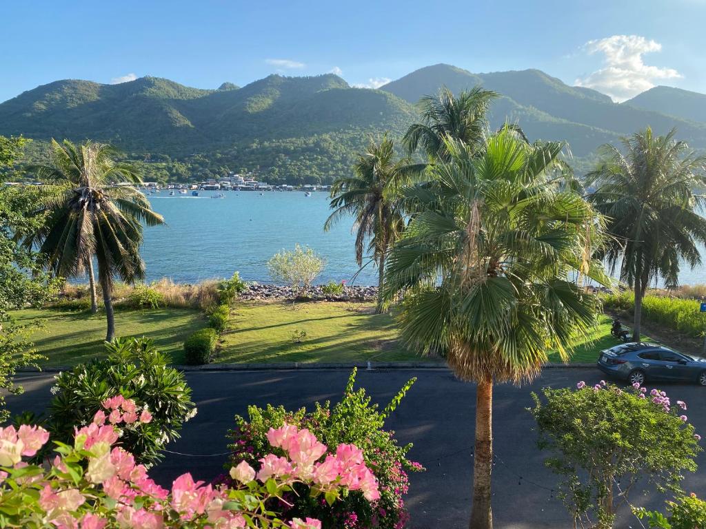 a view of a lake with palm trees and flowers at M Villa Nha Trang in Nha Trang