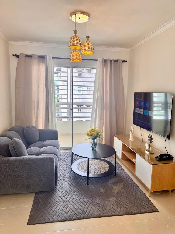 a living room with a couch and a coffee table at Oceanfront AC Wi-Fi Coffee Summer vacation in La Cana