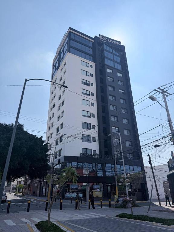 a tall black and white building on a city street at PISO 13 SM Living Street Mall in Puebla