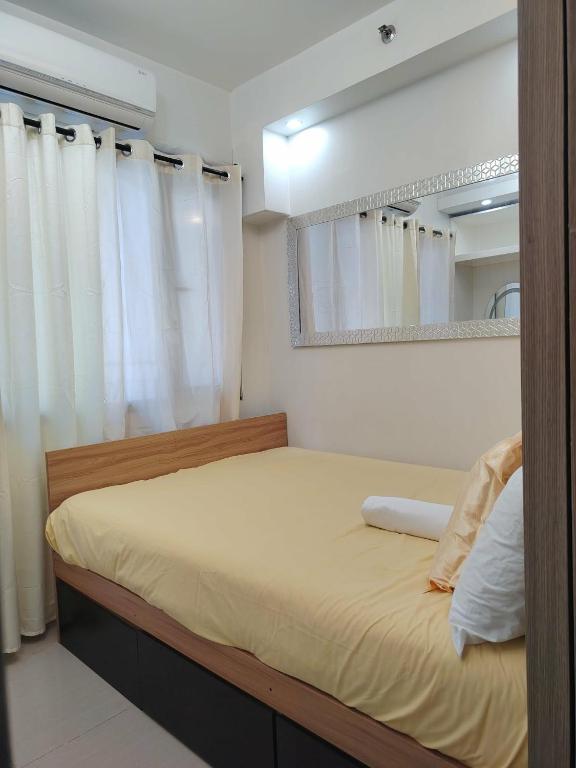 a bedroom with a bed and a mirror at VP luxury moa staycation in Manila