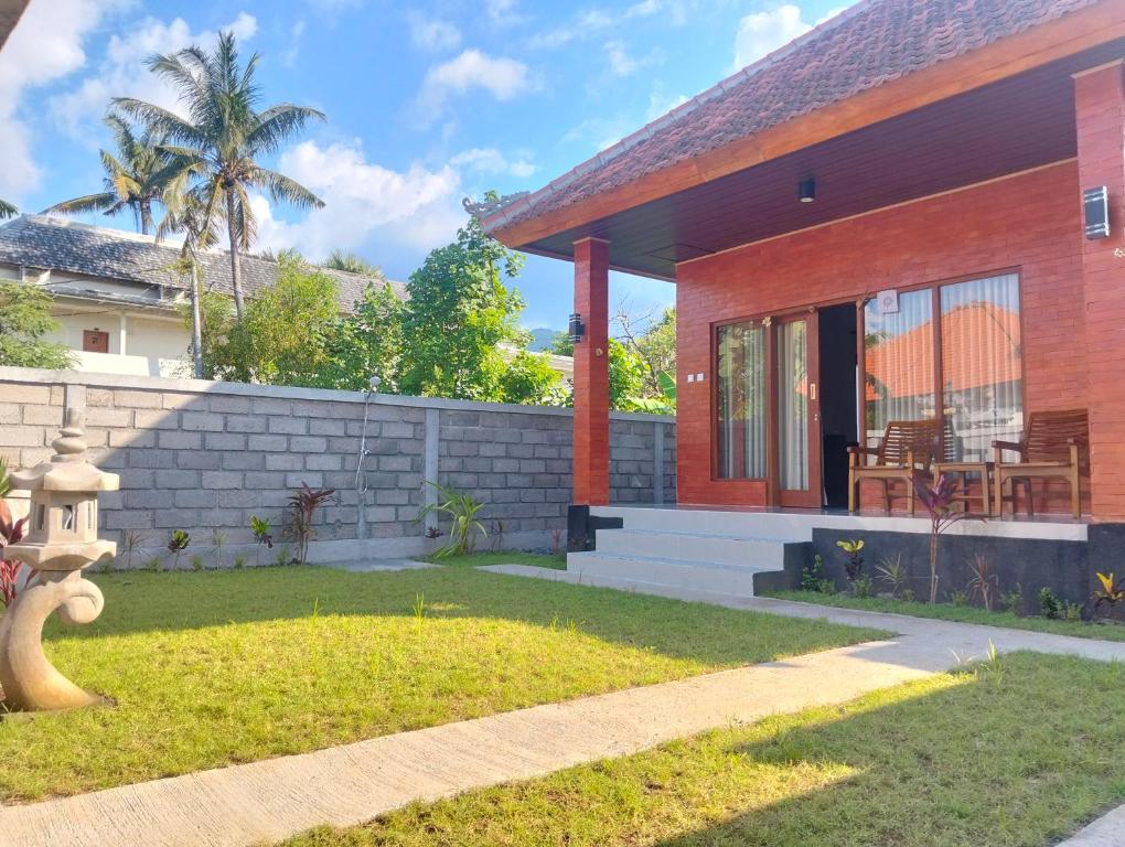 a house with a fire hydrant in front of it at Japa Amerta Villa in Amed