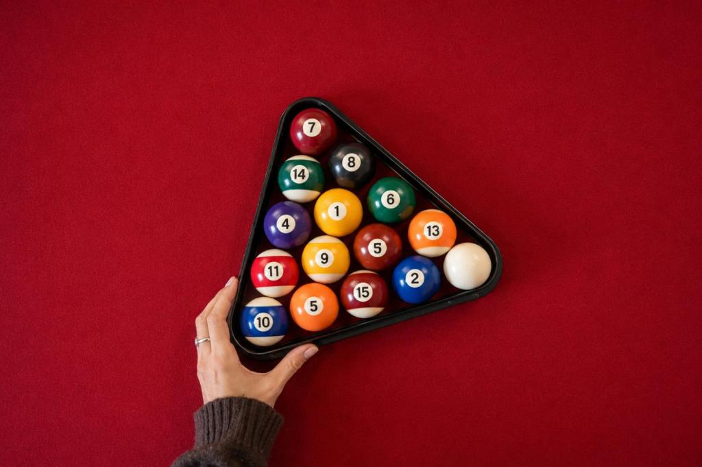 a person holding a pack of billiard balls at Geraldton Shoreline Lodge in Geraldton