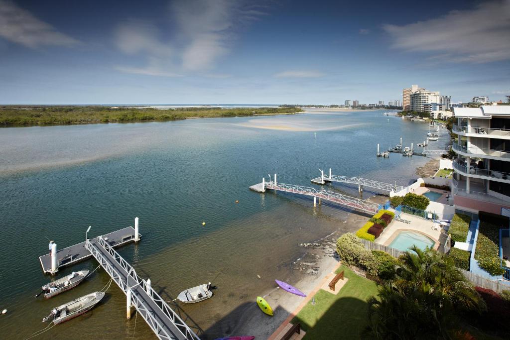 an aerial view of a river with boats docked at On The River Apartments in Maroochydore