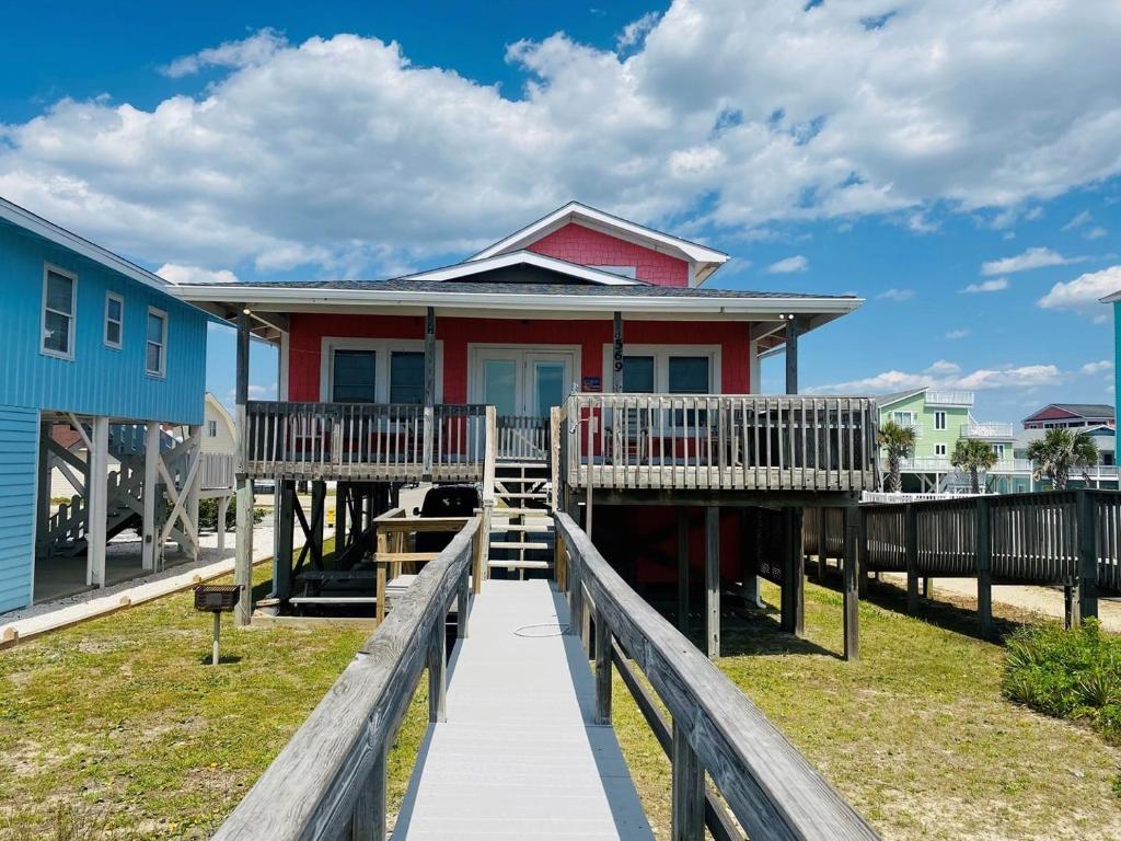a house with a boardwalk leading to a dock at 3 4 Time in Holden Beach