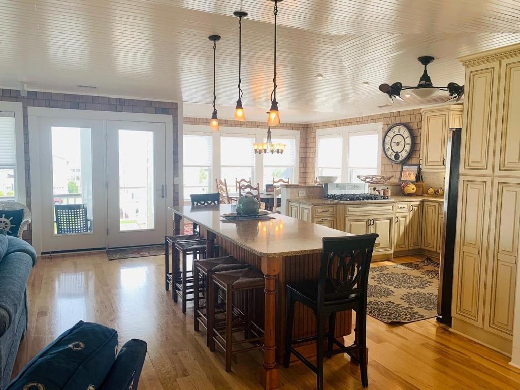 a kitchen with a large wooden table and chairs at Shore Beats Workin' in Holden Beach
