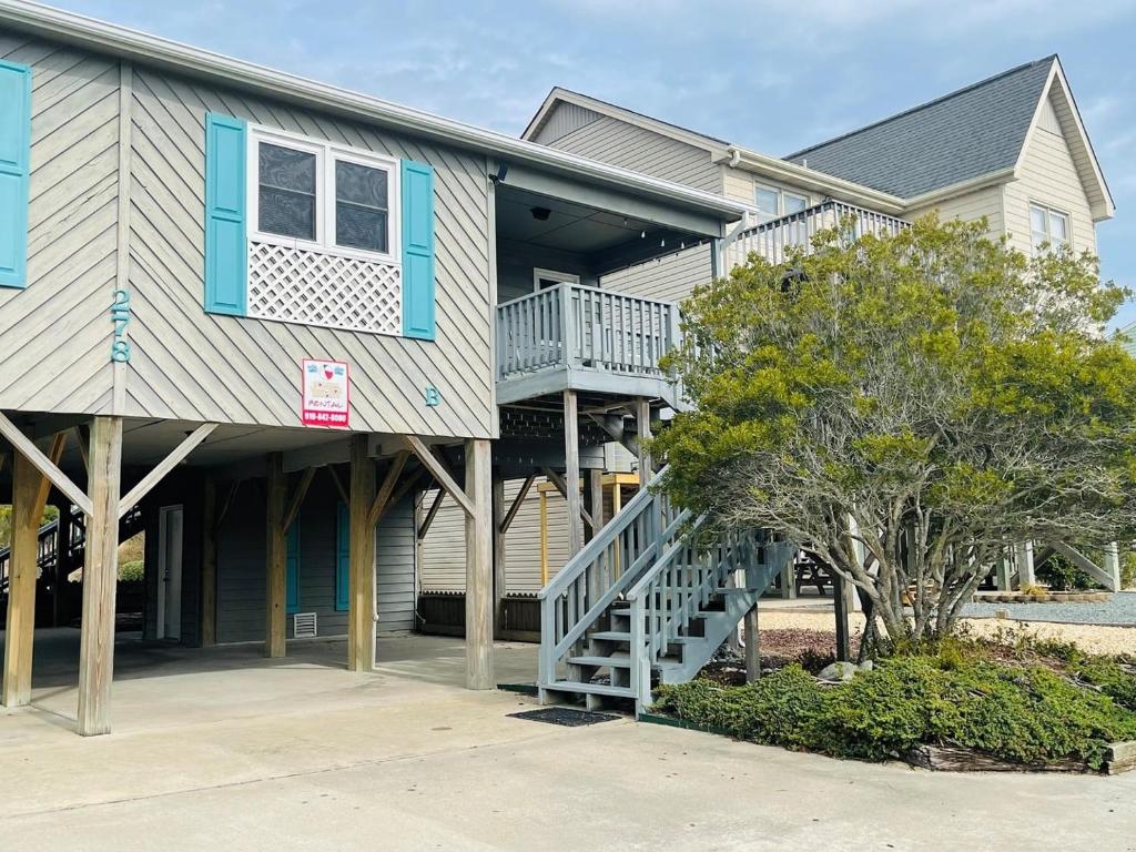 a house with a staircase in front of it at Plan Beach home in Holden Beach