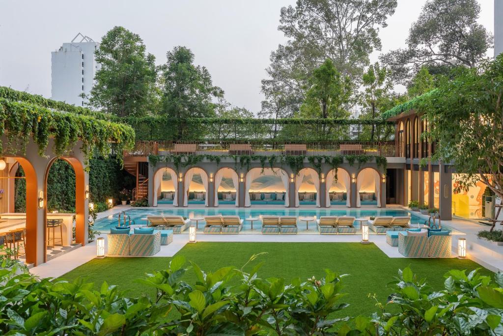 an external view of a building with a pool and grass at Meliá Pattaya Hotel in Pattaya
