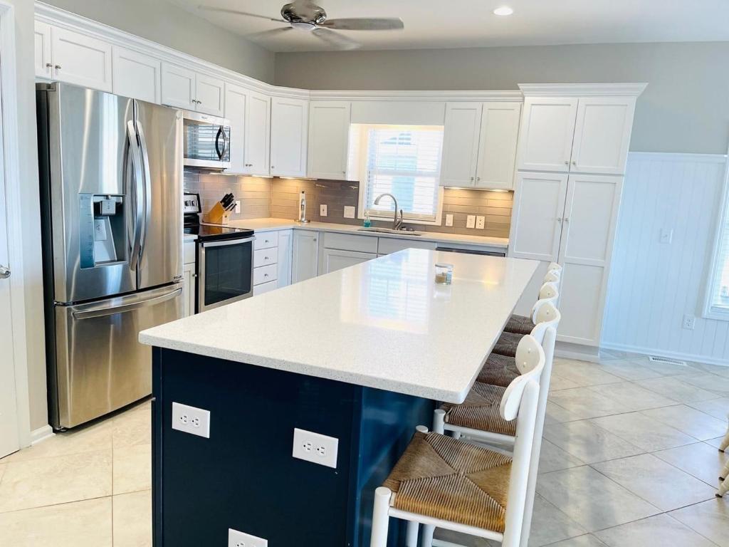 a kitchen with white cabinets and a white counter top at Avalon East-Duplex in Holden Beach