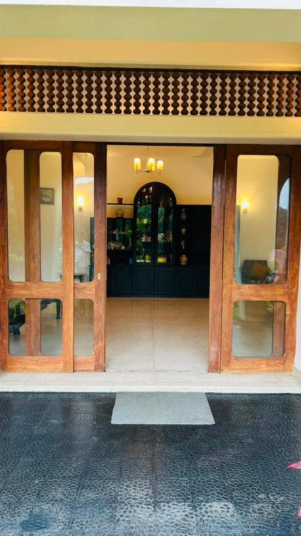 a front door of a building with wooden doors at Royal Eco Lodge in Kandy