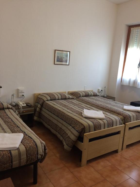 Postel nebo postele na pokoji v ubytování Hotel Bodoni
