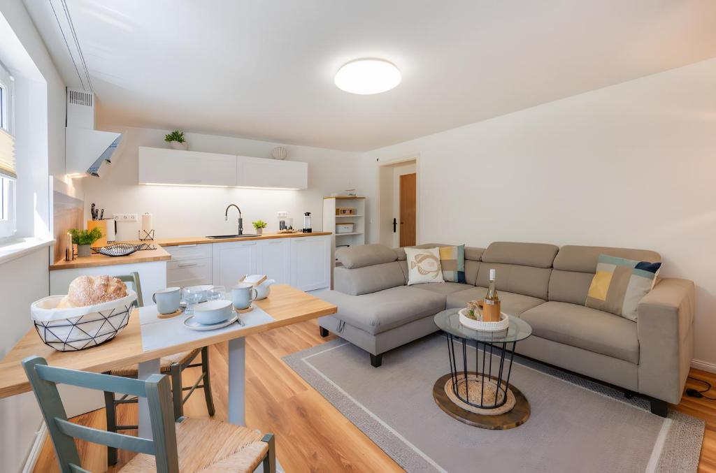 a living room with a couch and a table at Krauses Unterdeck in Loddin