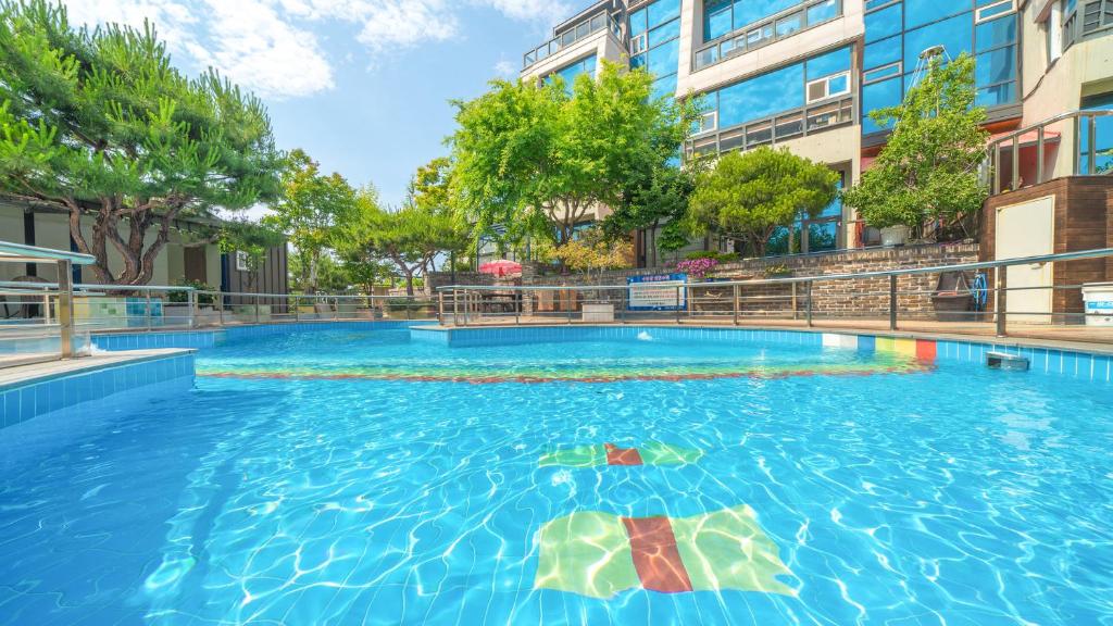 a large swimming pool in the middle of a building at goseong theprism pension in Goseong