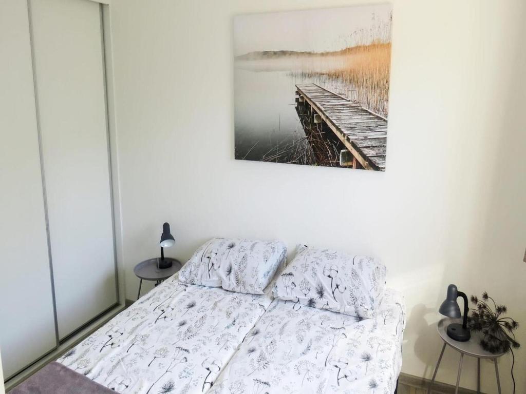 a bedroom with a bed and a painting on the wall at Charming Chalet Near Efteling in Kaatsheuvel