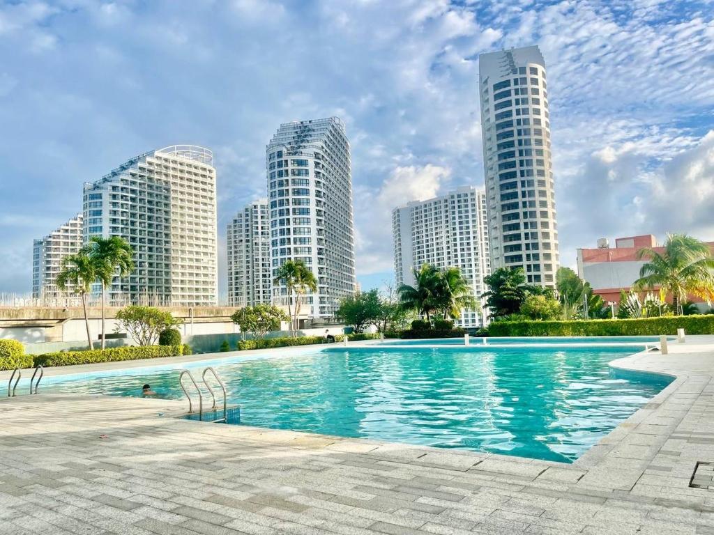 a swimming pool in a city with tall buildings at U Mall Condo in Sihanoukville
