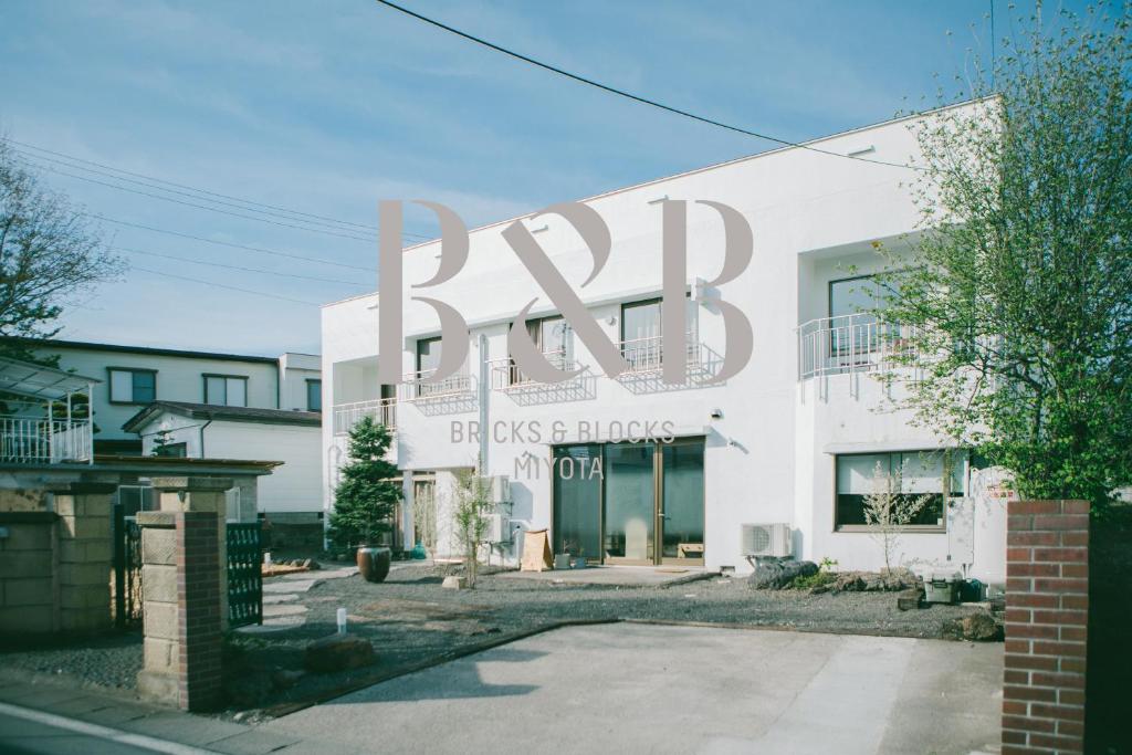 a building with a large sign on the side of it at BRICKS and BLOCKS MIYOTA in Miyota