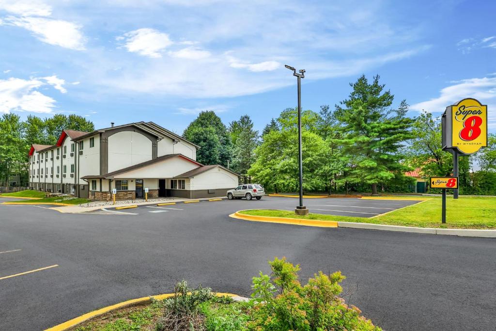 a building on the corner of a street with a gas station at Super 8 by Wyndham East Stroudsburg - Poconos in East Stroudsburg