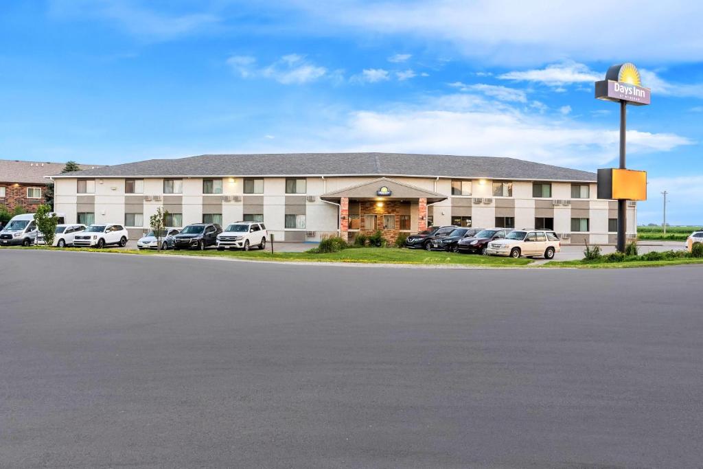 a hotel with cars parked in a parking lot at Days Inn by Wyndham York in York