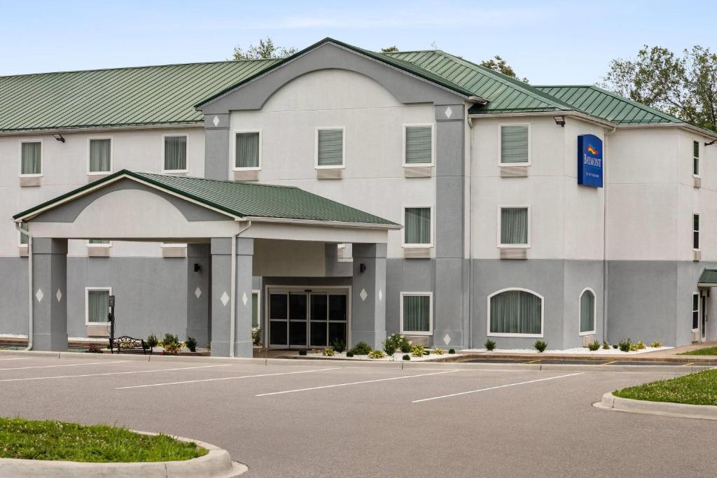 a large white building with a parking lot at Baymont by Wyndham La Grange KY Southeast in La Grange