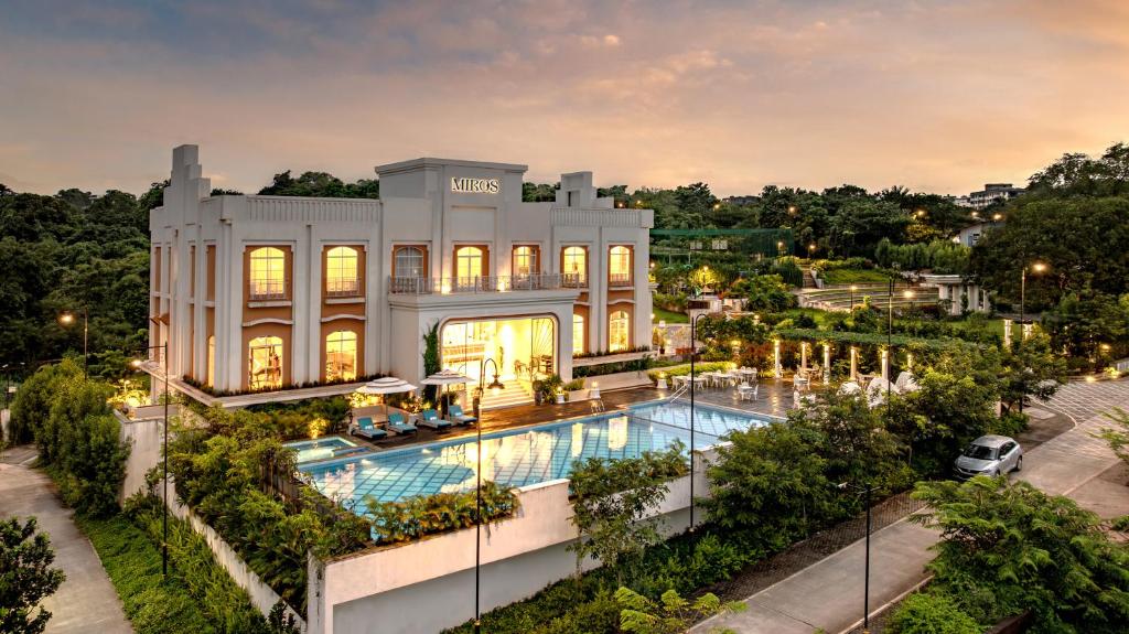 an aerial view of a mansion with a swimming pool at Miros, Goa in Old Goa