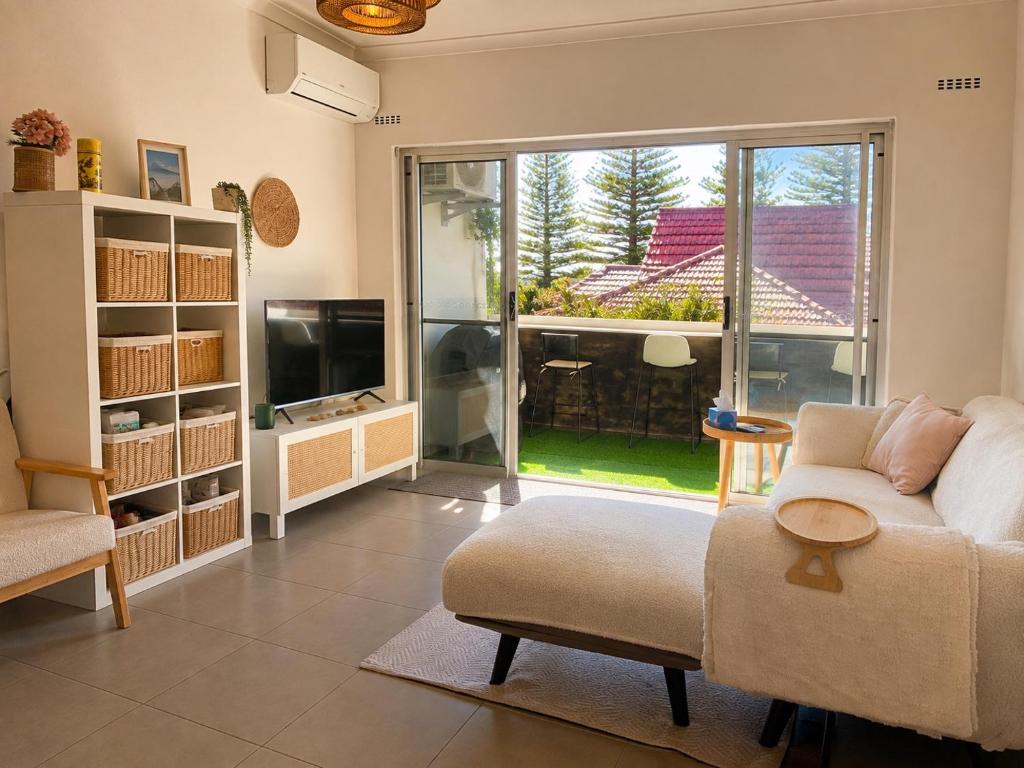 a living room with a couch and a large window at Ocean Eye in Perth
