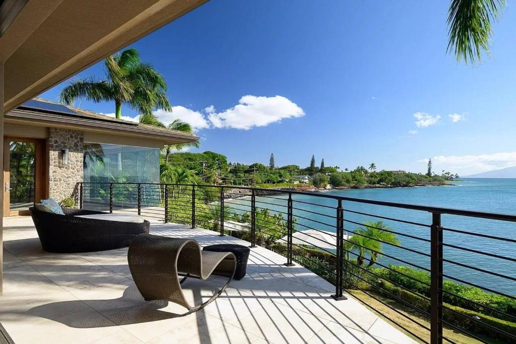 a balcony with a view of the ocean at Magnificent Oceanfront West Maui in Lahaina