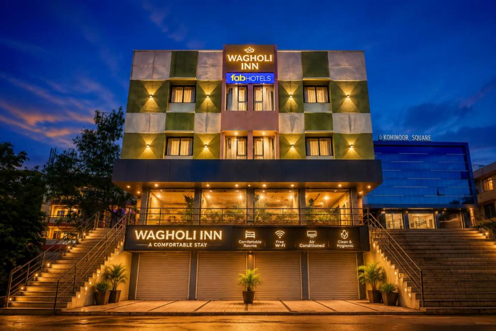 a hotel with a sign that reads watchful inn at FabHotel Wagholi Inn in Pune
