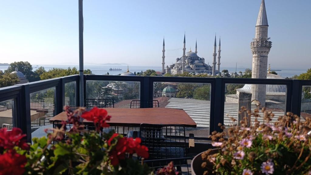 a balcony with a table and a view of the blue mosque at Nomade Old City Hotel in Istanbul